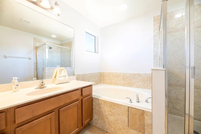 bathroom featuring shower with separate bathtub and vanity