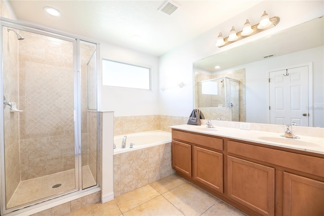 bathroom featuring tile patterned floors, separate shower and tub, and vanity