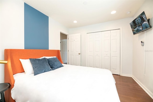 bedroom with a closet and dark hardwood / wood-style flooring