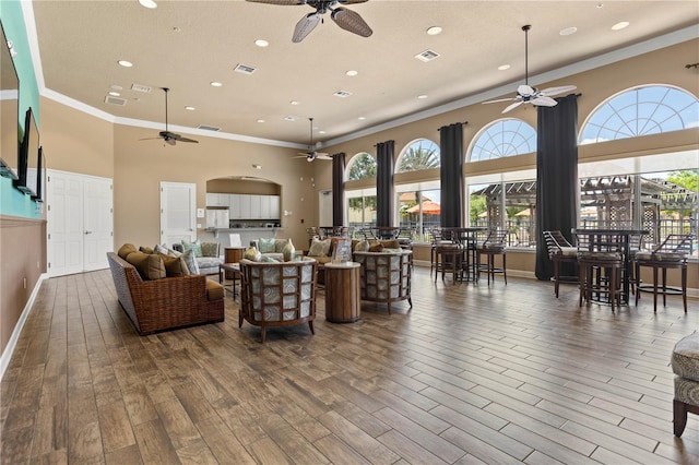 living room featuring a wealth of natural light, ceiling fan, and hardwood / wood-style flooring