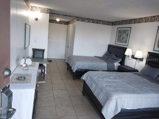 tiled bedroom with a textured ceiling