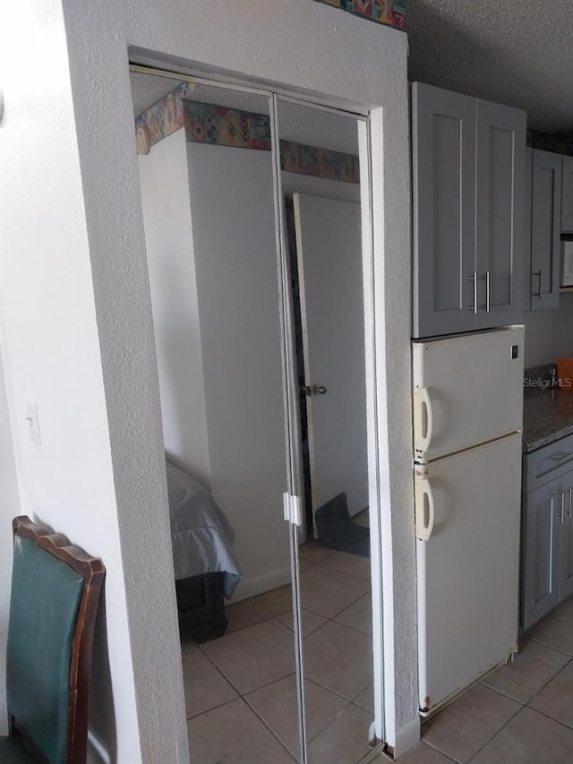 43420 Hwy 27 Unit 361, Davenport, FL 33837 - hallway featuring light tile patterned flooring and a textured ceiling