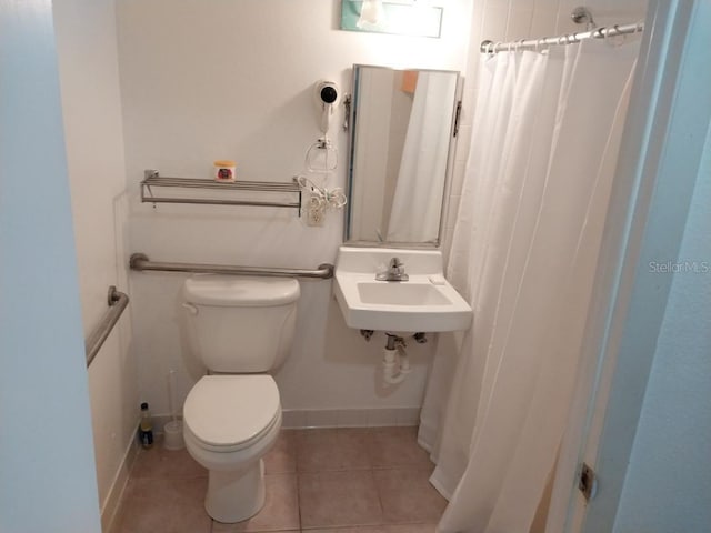 bathroom with a shower with shower curtain, sink, tile patterned floors, and toilet