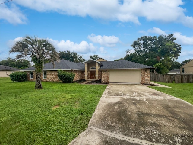 ranch-style home with a garage and a front lawn