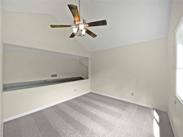 carpeted spare room featuring lofted ceiling and ceiling fan