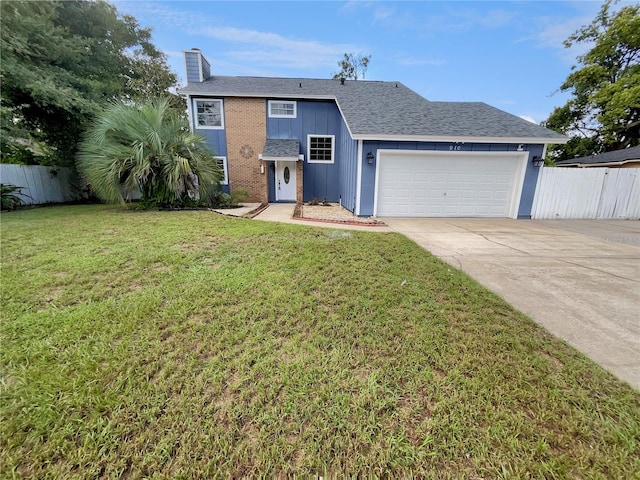 view of front of property featuring a front yard and a garage