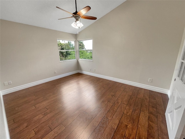 spare room with vaulted ceiling, ceiling fan, and dark hardwood / wood-style floors