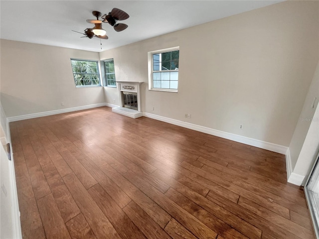 unfurnished living room featuring ceiling fan and hardwood / wood-style flooring