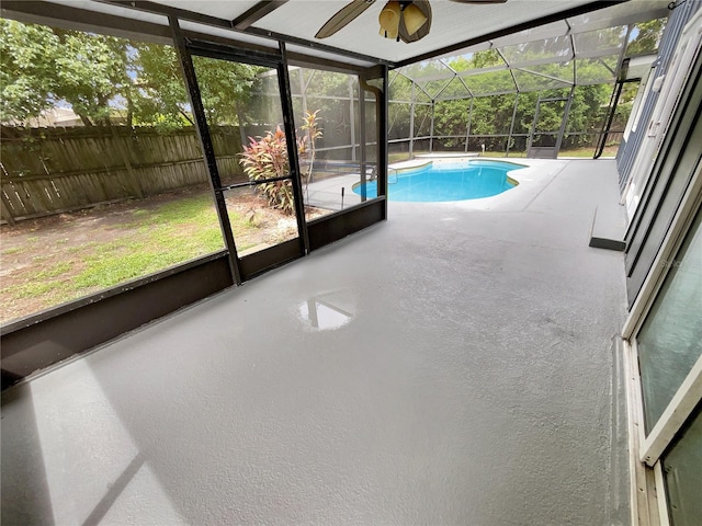 unfurnished sunroom featuring ceiling fan