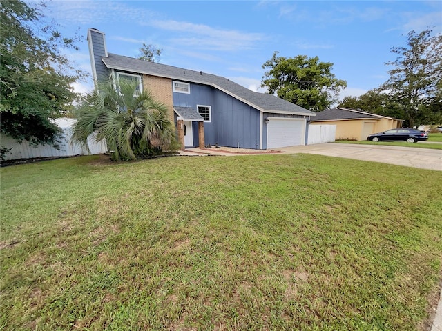 view of front of property with a garage and a front lawn