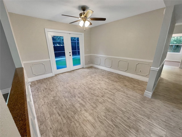 spare room with french doors, ceiling fan, and hardwood / wood-style floors