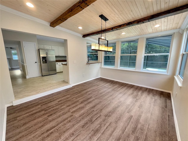 interior space with wood-type flooring, beamed ceiling, wooden ceiling, and crown molding