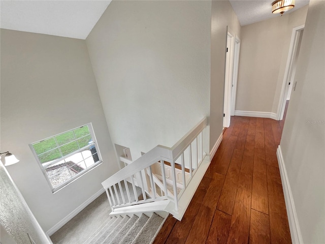 corridor with hardwood / wood-style flooring