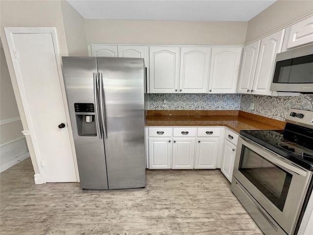 kitchen featuring decorative backsplash, light hardwood / wood-style floors, white cabinetry, and stainless steel appliances