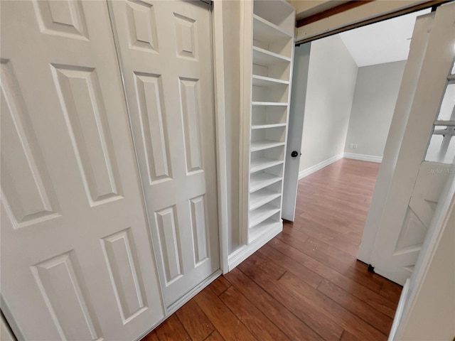 hallway with hardwood / wood-style flooring