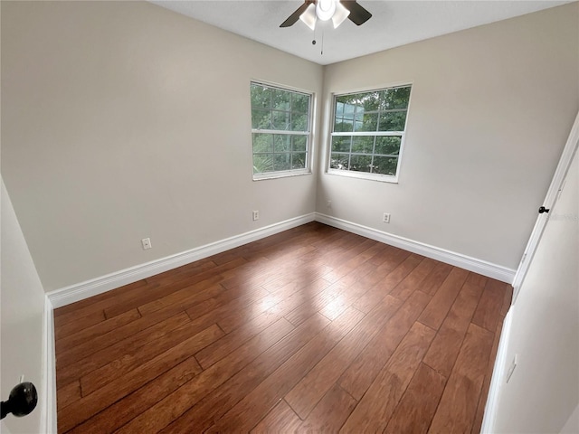 unfurnished room with dark hardwood / wood-style flooring and ceiling fan