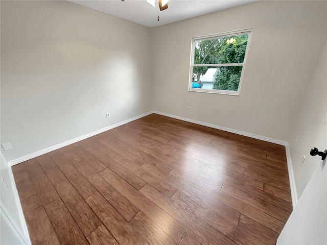 empty room with ceiling fan and hardwood / wood-style flooring