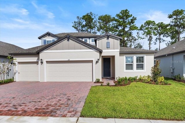 view of front of home with a garage and a front lawn