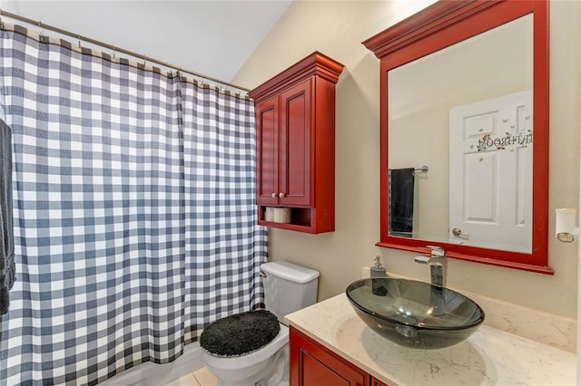 bathroom with vanity, toilet, and lofted ceiling