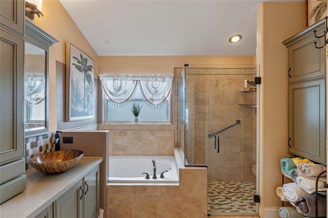 bathroom featuring vanity and independent shower and bath