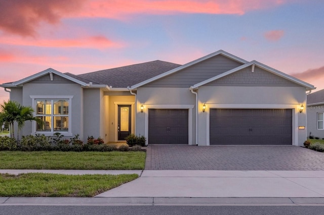 view of front of house featuring a lawn and a garage