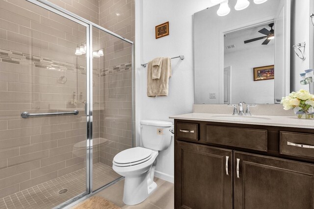 bathroom with ceiling fan, walk in shower, tile patterned flooring, toilet, and vanity