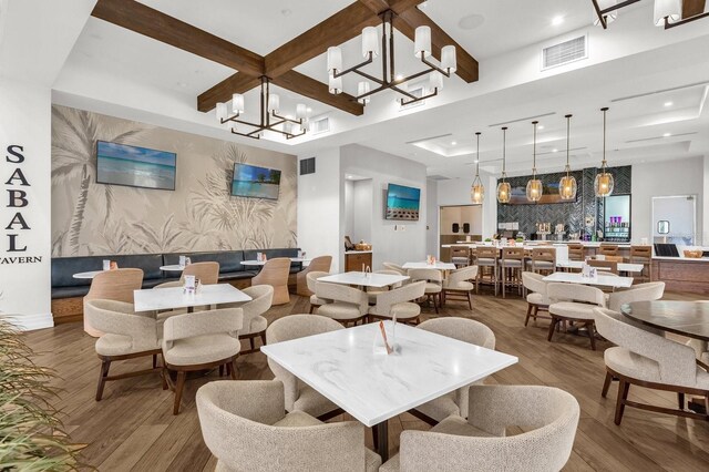 dining area featuring wood-type flooring and a chandelier