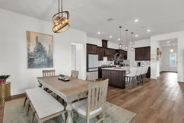 dining room with a notable chandelier and dark wood-type flooring