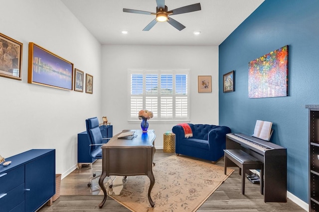 home office featuring wood-type flooring and ceiling fan