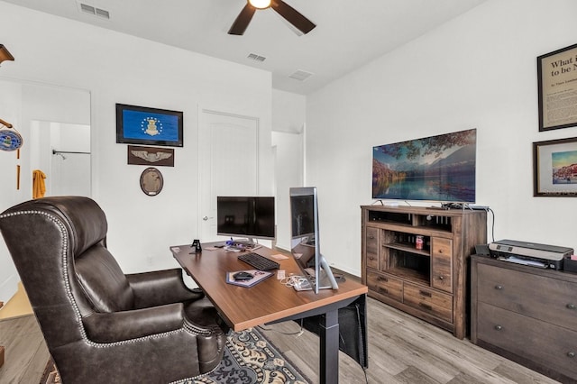 home office featuring light wood-type flooring and ceiling fan