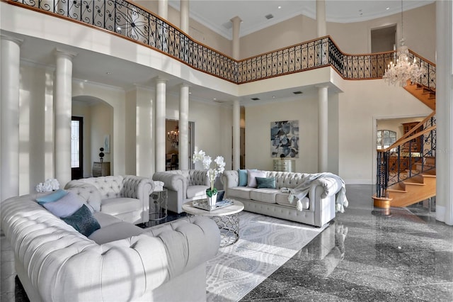 living room with ornamental molding, a towering ceiling, and ornate columns