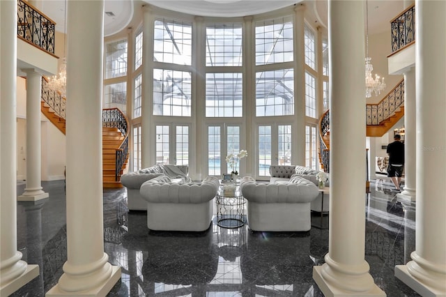 living room with a high ceiling and a wealth of natural light