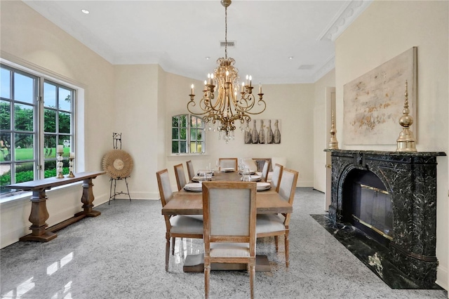 dining room with a notable chandelier, a high end fireplace, carpet flooring, and crown molding