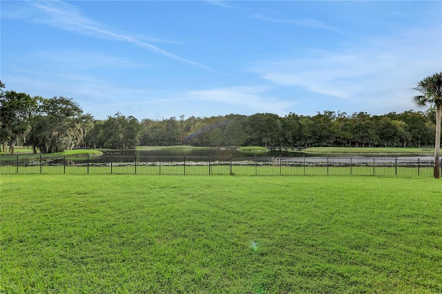 view of yard with a water view and a rural view