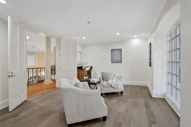 sitting room with light hardwood / wood-style floors, ornamental molding, and plenty of natural light