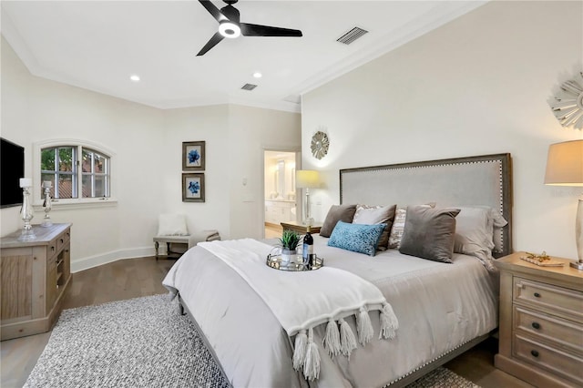 bedroom with connected bathroom, ceiling fan, crown molding, and dark hardwood / wood-style flooring