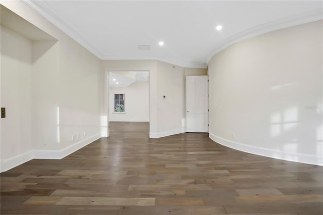 spare room featuring ornamental molding and dark hardwood / wood-style flooring