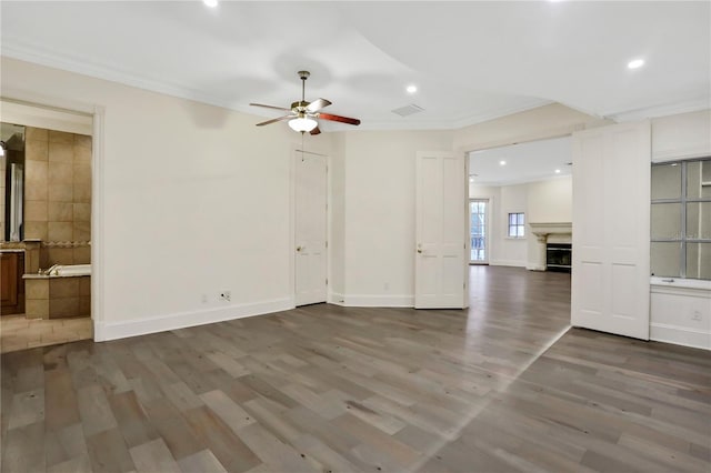 interior space with crown molding, dark hardwood / wood-style floors, and ceiling fan