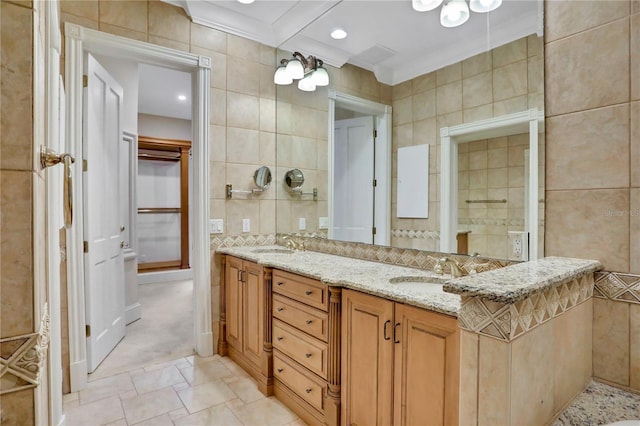 bathroom featuring vanity, tile walls, and crown molding