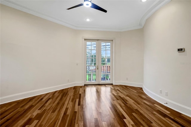 spare room with ceiling fan, hardwood / wood-style flooring, crown molding, and french doors