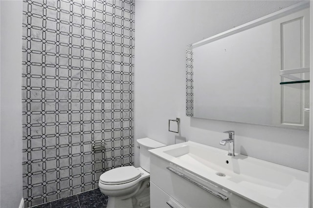 bathroom with tile patterned flooring, vanity, and toilet