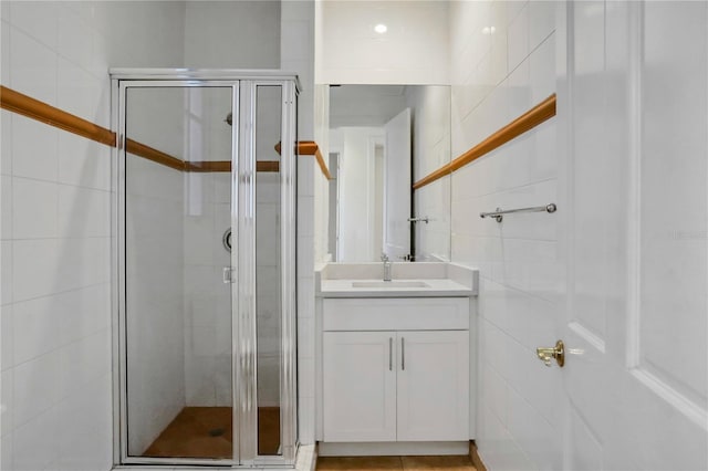 bathroom with vanity and a shower with shower door