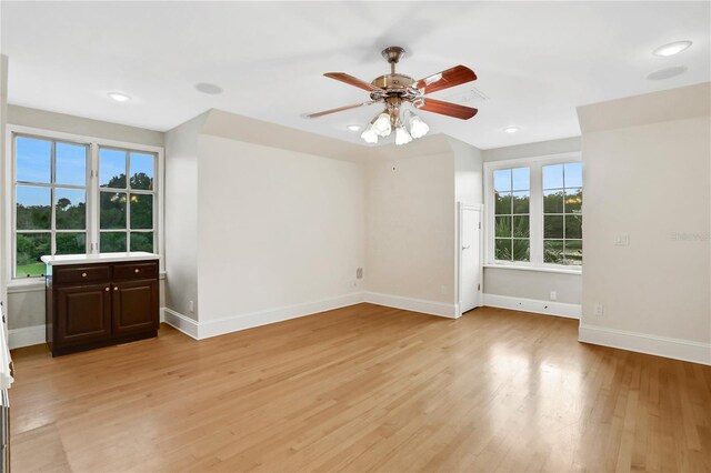 spare room featuring ceiling fan and light hardwood / wood-style flooring