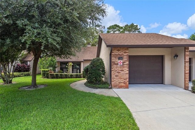 view of front of property with a garage and a front lawn