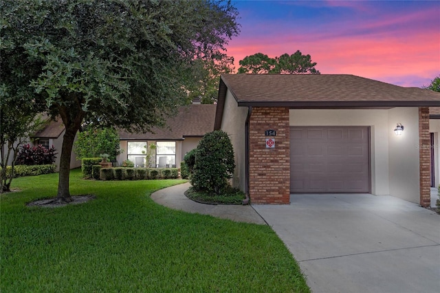 view of front facade with a garage and a yard