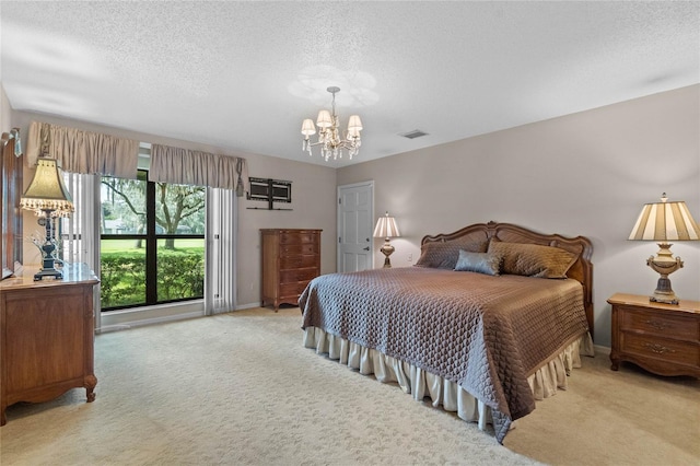 carpeted bedroom with an inviting chandelier and a textured ceiling