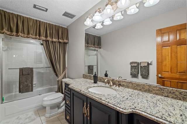 full bathroom with vanity, toilet, a textured ceiling, bath / shower combo with glass door, and tile patterned flooring