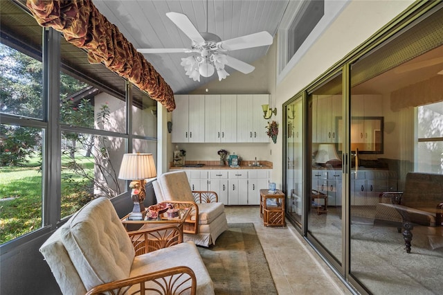 sunroom / solarium featuring lofted ceiling and ceiling fan