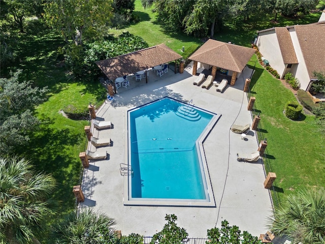 view of pool with a lawn and a patio area