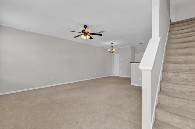 interior space featuring light colored carpet and ceiling fan with notable chandelier